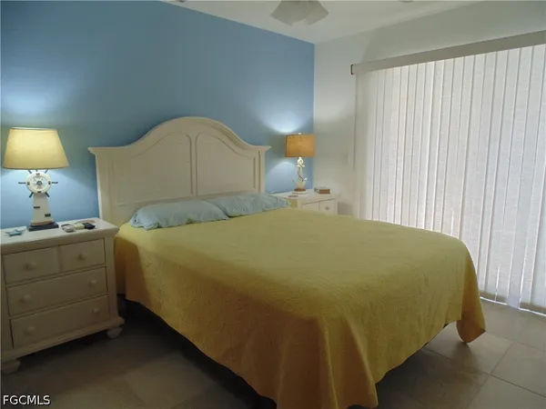 a bed sitting in a bedroom next to a lamp