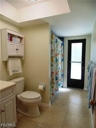 a bathroom with a toilet and a shower
