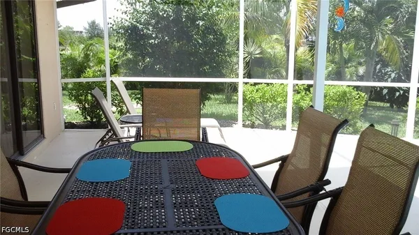 a outdoor dining table with chairs and wooden floor