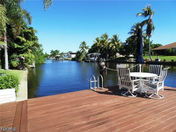 a view of a wooden deck and lake view