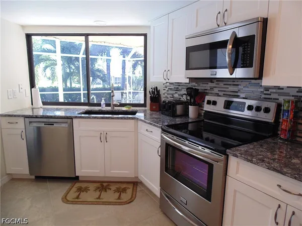 a kitchen with a stove and a microwave