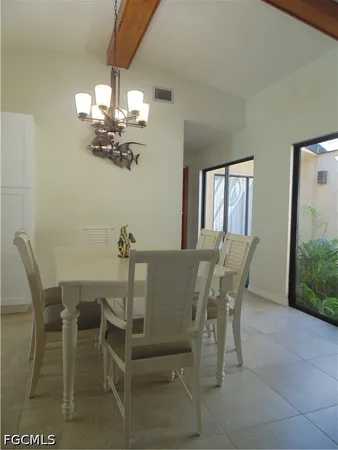a view of a dining room with furniture and chandelier