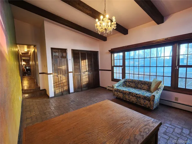 a living room with furniture and a chandelier