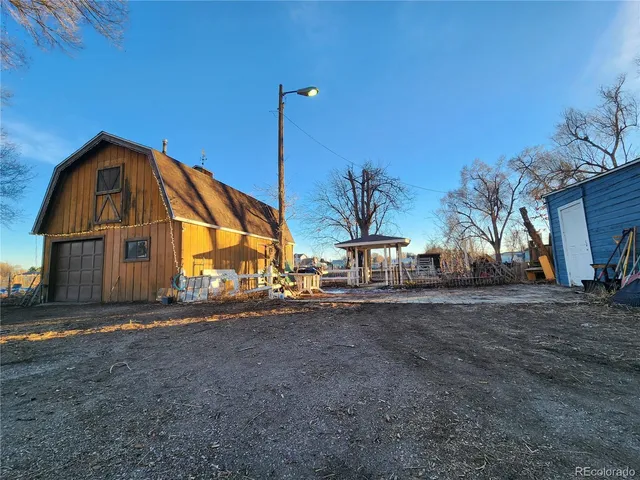 a view of a house with a yard and a garage