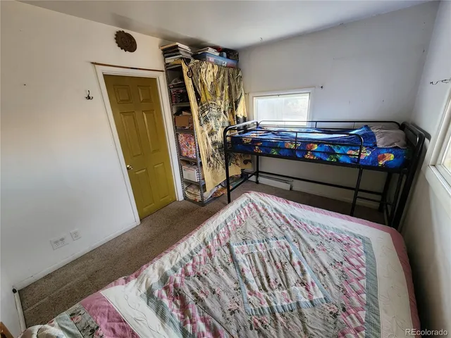 a bed sitting in a bedroom next to a window