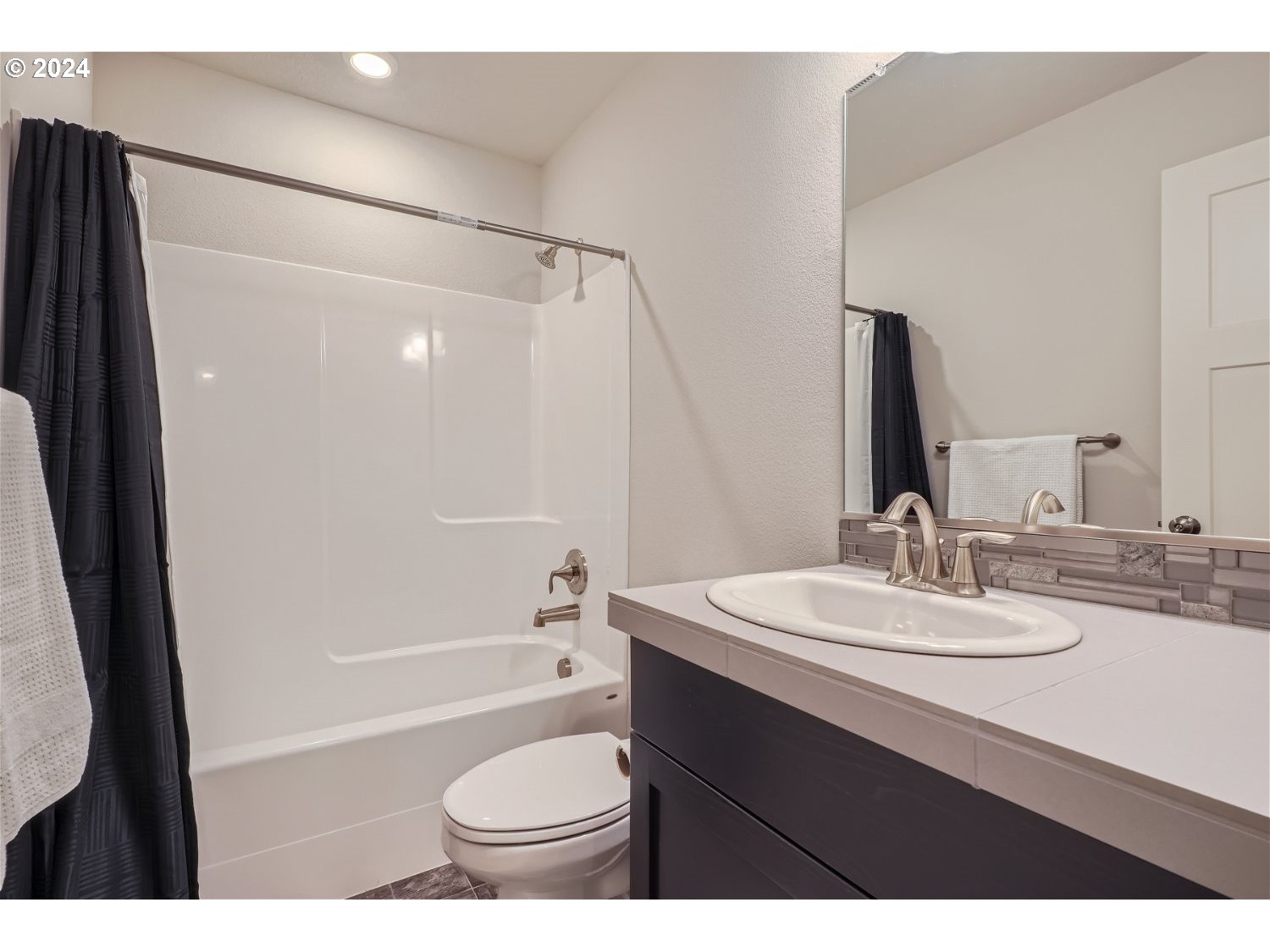 2348 South Trail View Ridgefield, WA 98642 - Photo 25 of 28 a bathroom with a sink toilet a mirror and shower