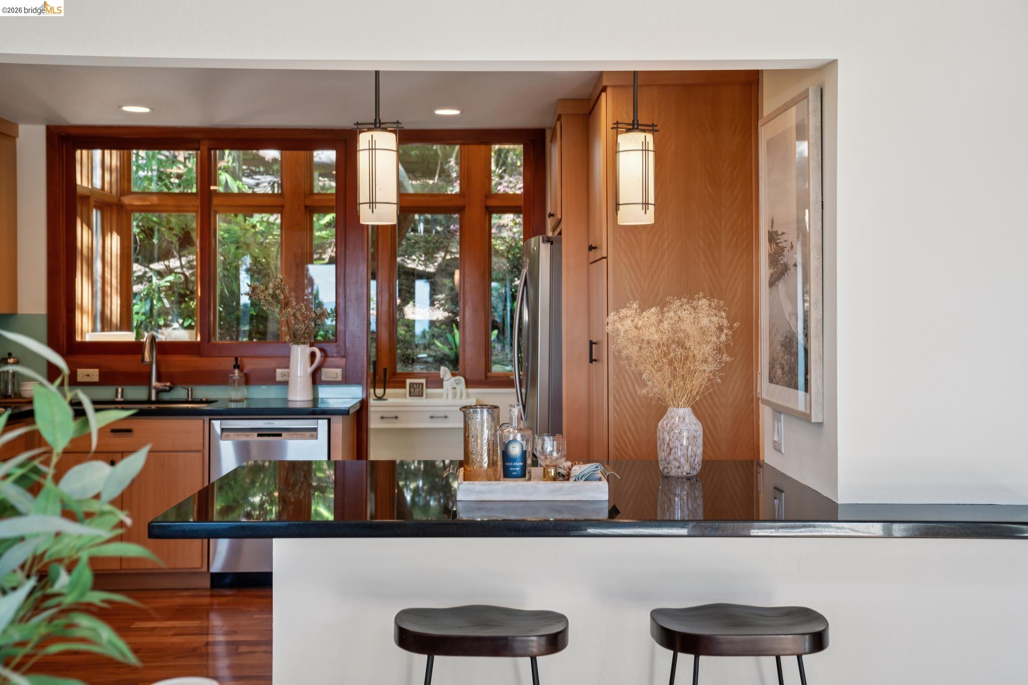 1183 Keeler Avenue Berkeley, CA 94708 - Photo 23 of 53 Kitchen featuring stainless steel appliances, a kitchen breakfast bar, healthy amount of natural light, and wood finish cabinetry