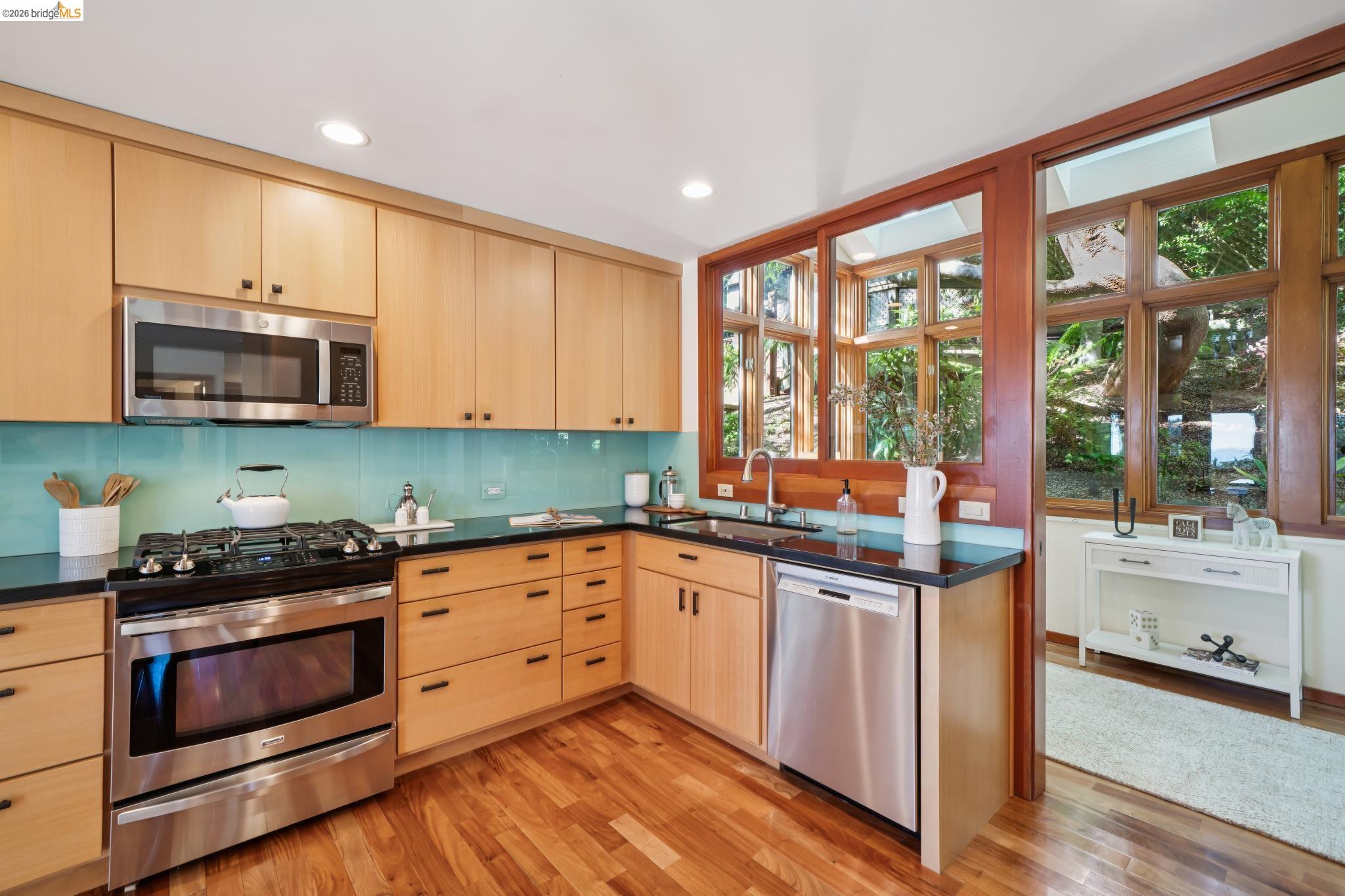 1183 Keeler Avenue Berkeley, CA 94708 - Photo 24 of 53 Kitchen with light wood finish cabinetry, stainless steel appliances, light wood-type flooring, tasteful backsplash, and recessed lighting