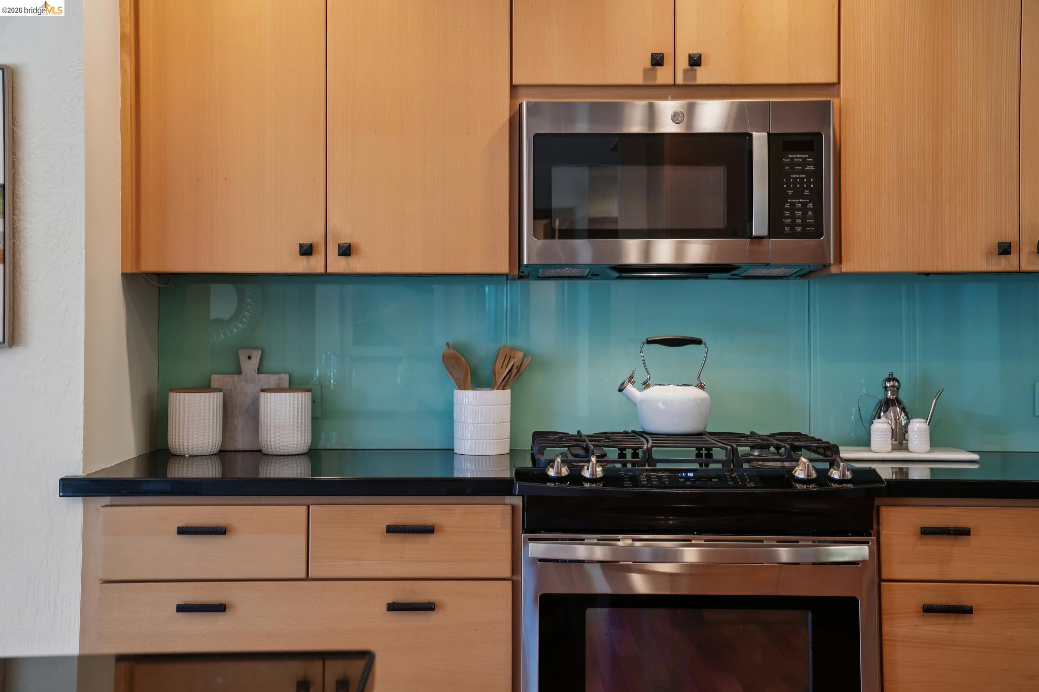 1183 Keeler Avenue Berkeley, CA 94708 - Photo 25 of 53 Kitchen featuring stainless steel appliances, light wood finish cabinets, and dark stone counters