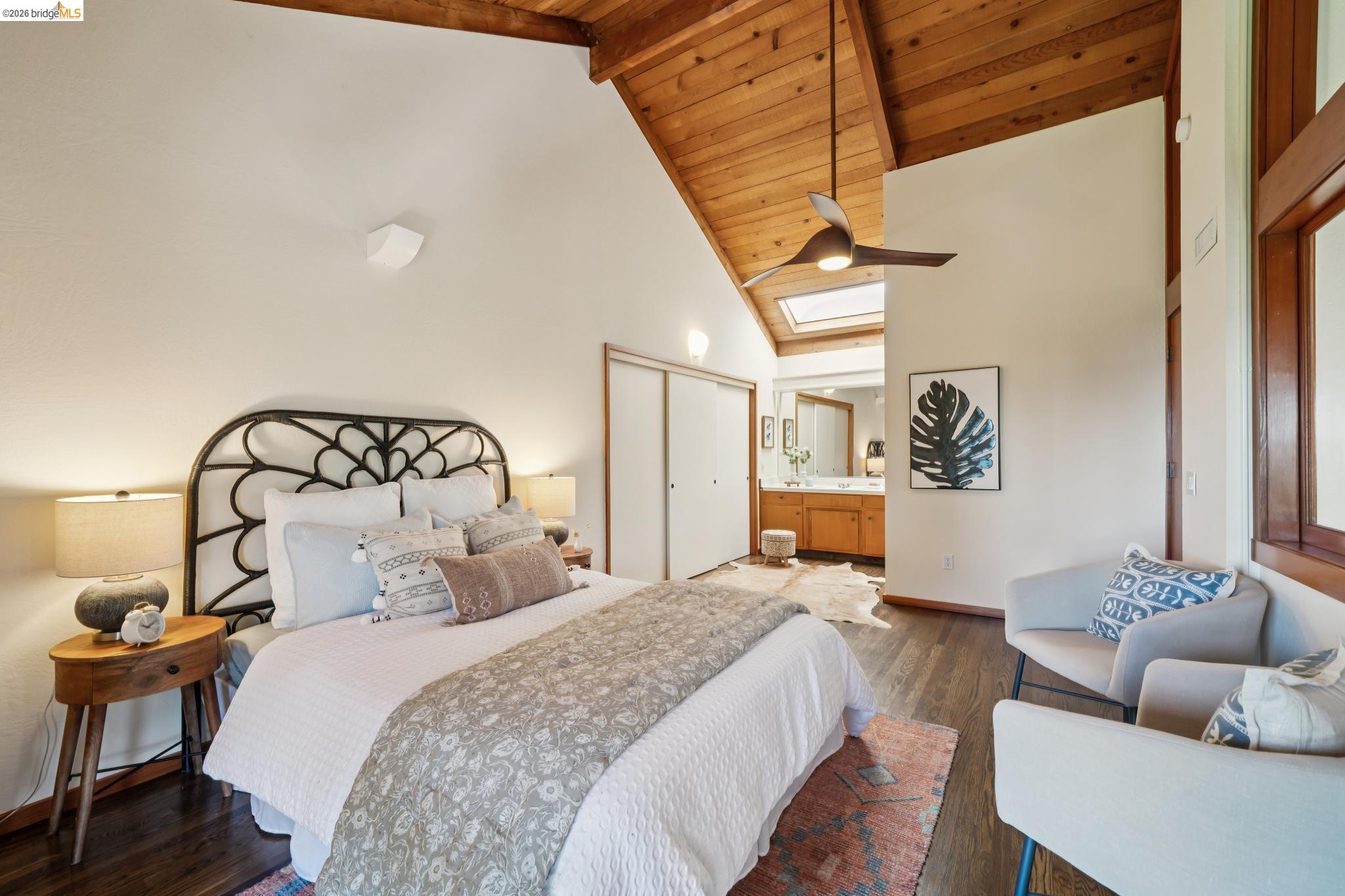 1183 Keeler Avenue Berkeley, CA 94708 - Photo 36 of 53 Bedroom featuring wood finished floors, ensuite bathroom, a high wood beamed ceiling, a skylight, and a closet