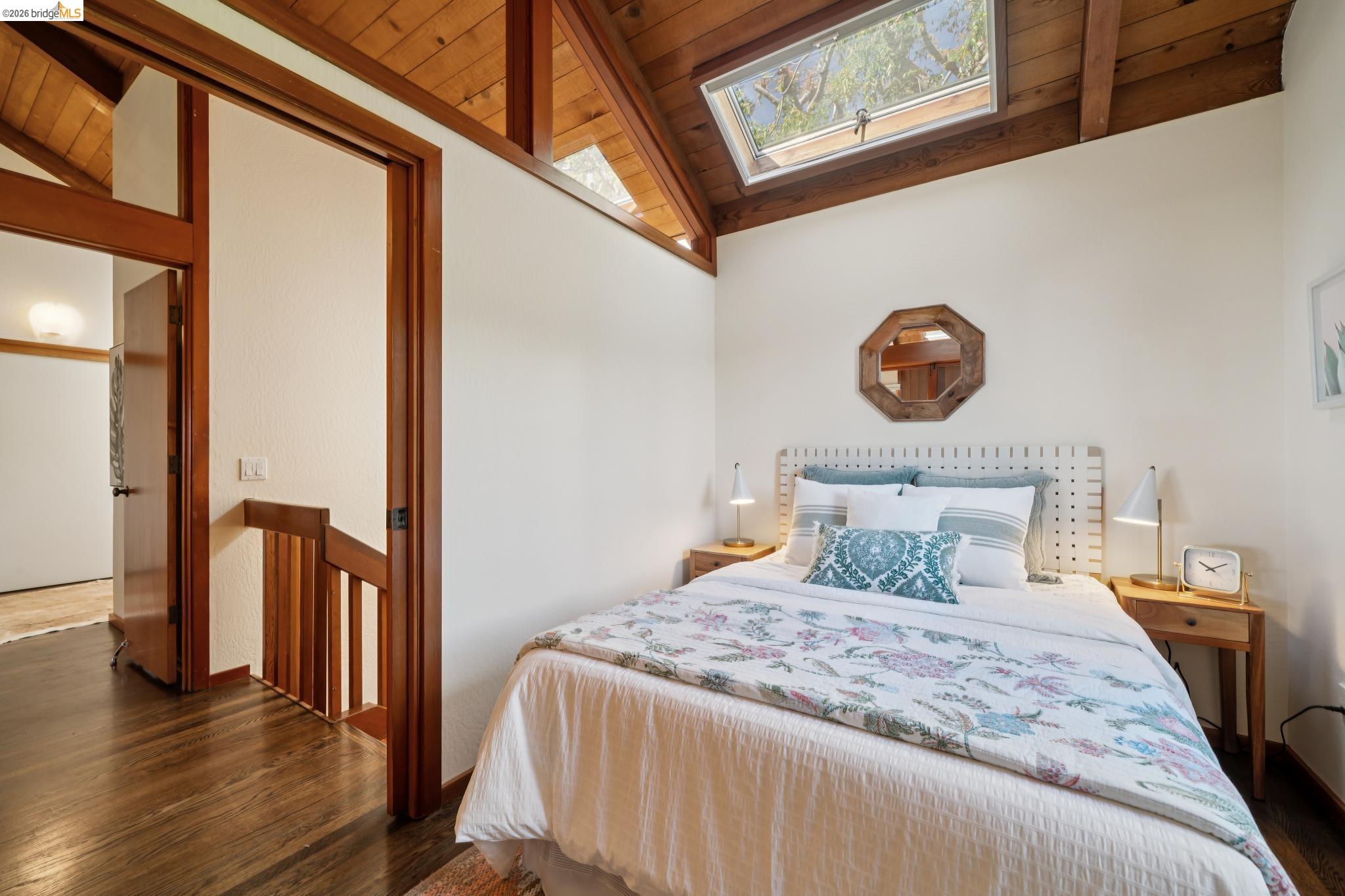 1183 Keeler Avenue Berkeley, CA 94708 - Photo 41 of 53 Bedroom featuring a skylight, vaulted ceiling with beams, wood ceiling, and wood finished floors