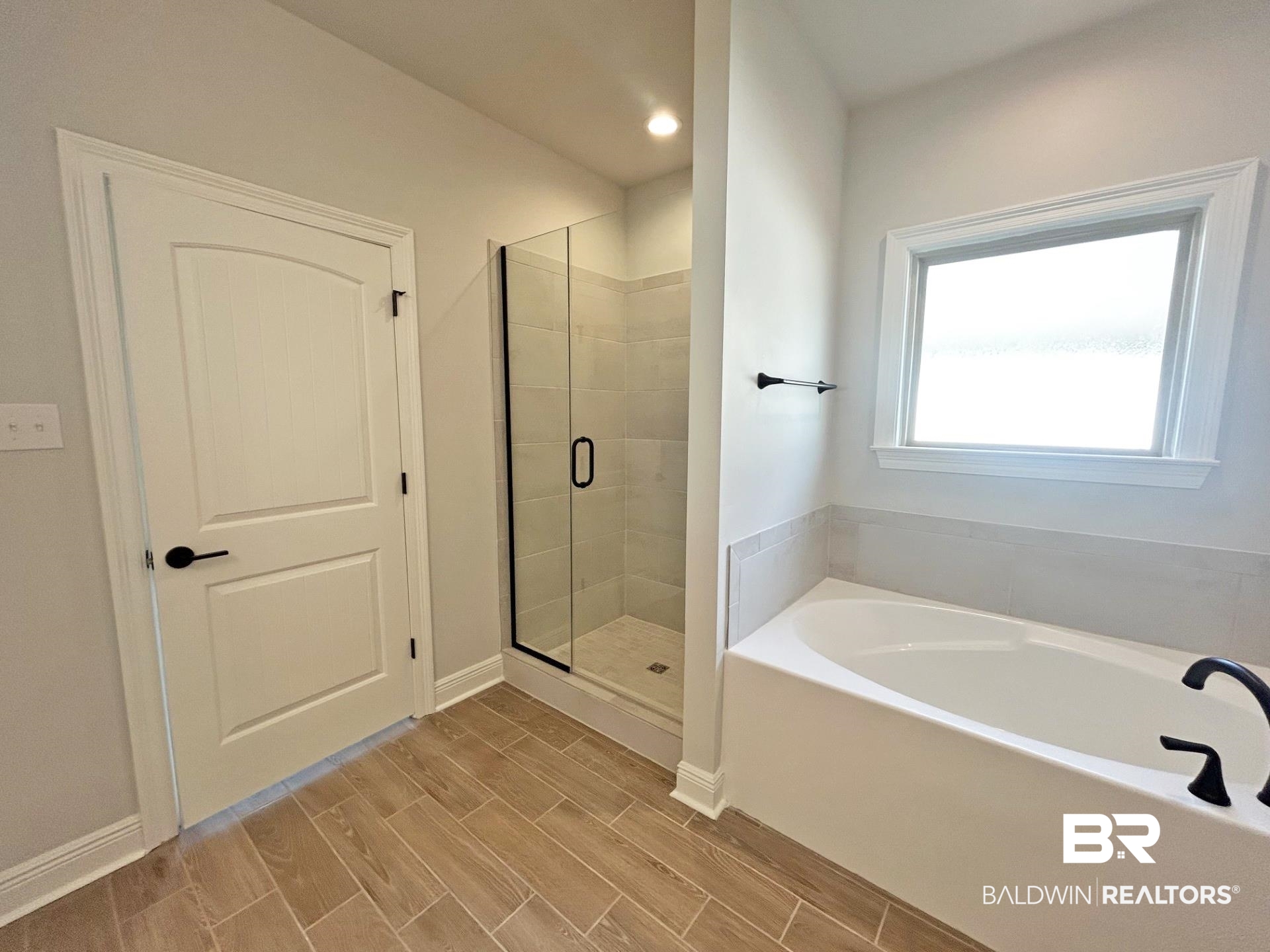 825 Sumter Loop Foley, AL 36535 - Photo 10 of 21 Bathroom with a garden tub, wood tiled floors, a shower stall, and recessed lighting