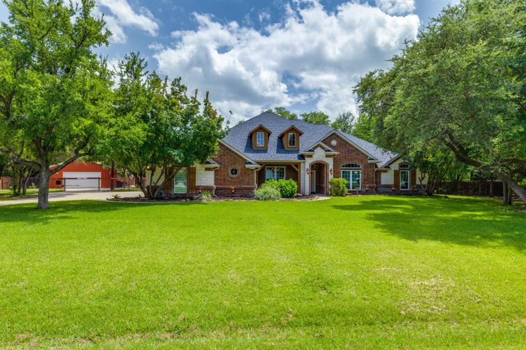 a front view of house with yard and green space