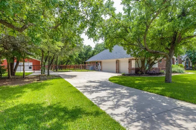 a view of a house with a yard and tree s