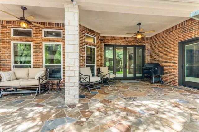 a view of a livingroom with furniture and floor to ceiling window