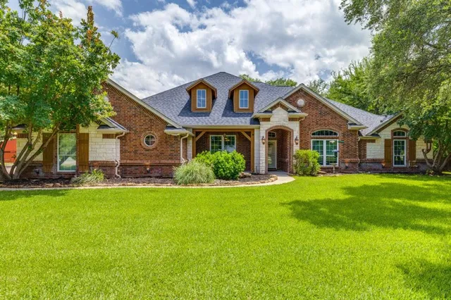 a front view of house with yard and green space