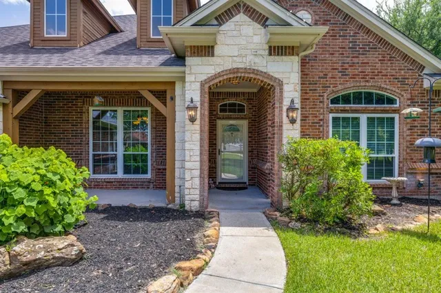 a front view of a house with garden