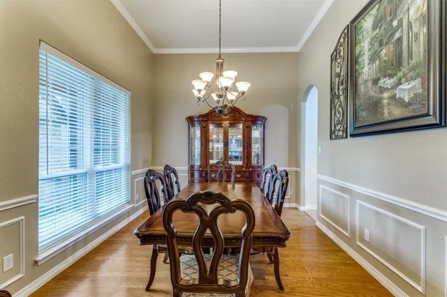 a view of a dining room with furniture wooden floor and chandelier