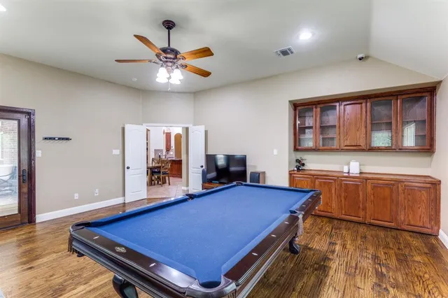 a room with furniture pool table and flat screen tv