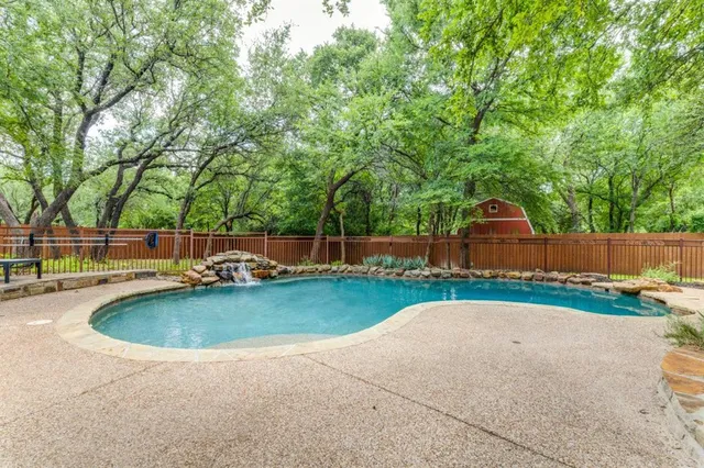 a view of a backyard with swimming pool