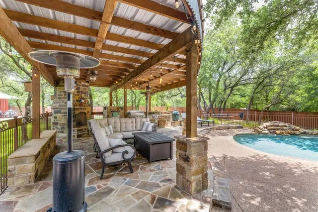 a view of a patio with couches chairs and large trees