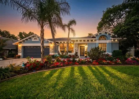a view of a house with a big yard and potted plants