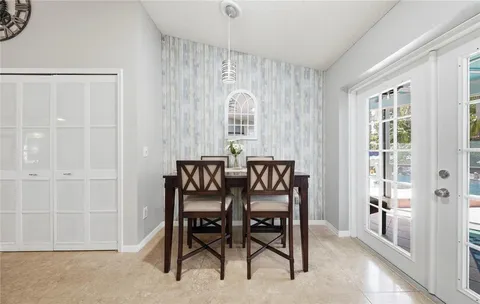 a dining room with furniture and window