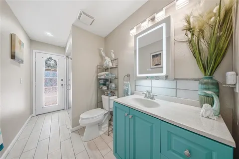 a bathroom with a sink a toilet and a mirror