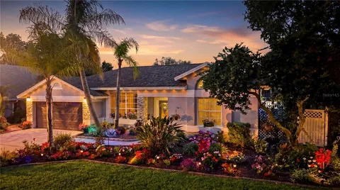 a view of a house with a backyard and garden