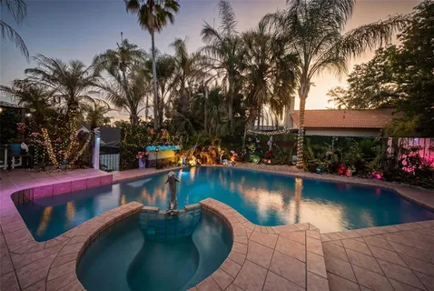a view of swimming pool with outdoor seating and lake view