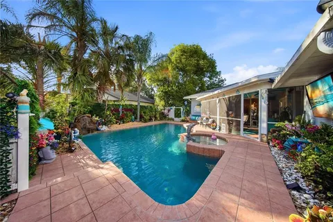 a view of a house with swimming pool and sitting area