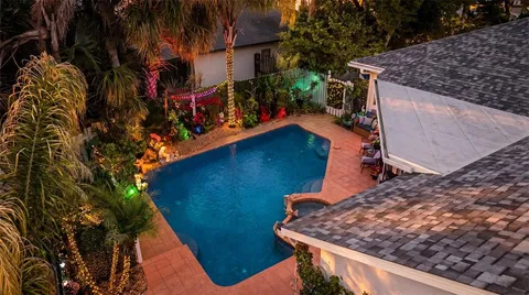 a view of a patio with table and chairs potted plants and palm tree