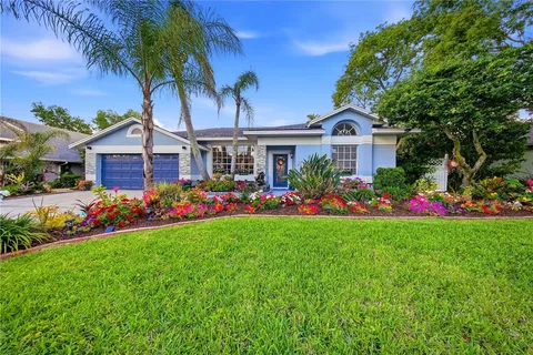 a front view of a house with a garden and yard