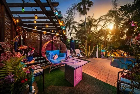 a backyard of a house with outdoor seating