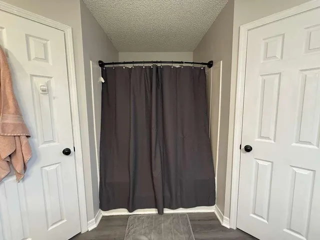 a view of a closet with wooden floor