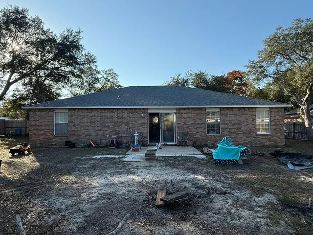 a view of a chairs and table in the backyard