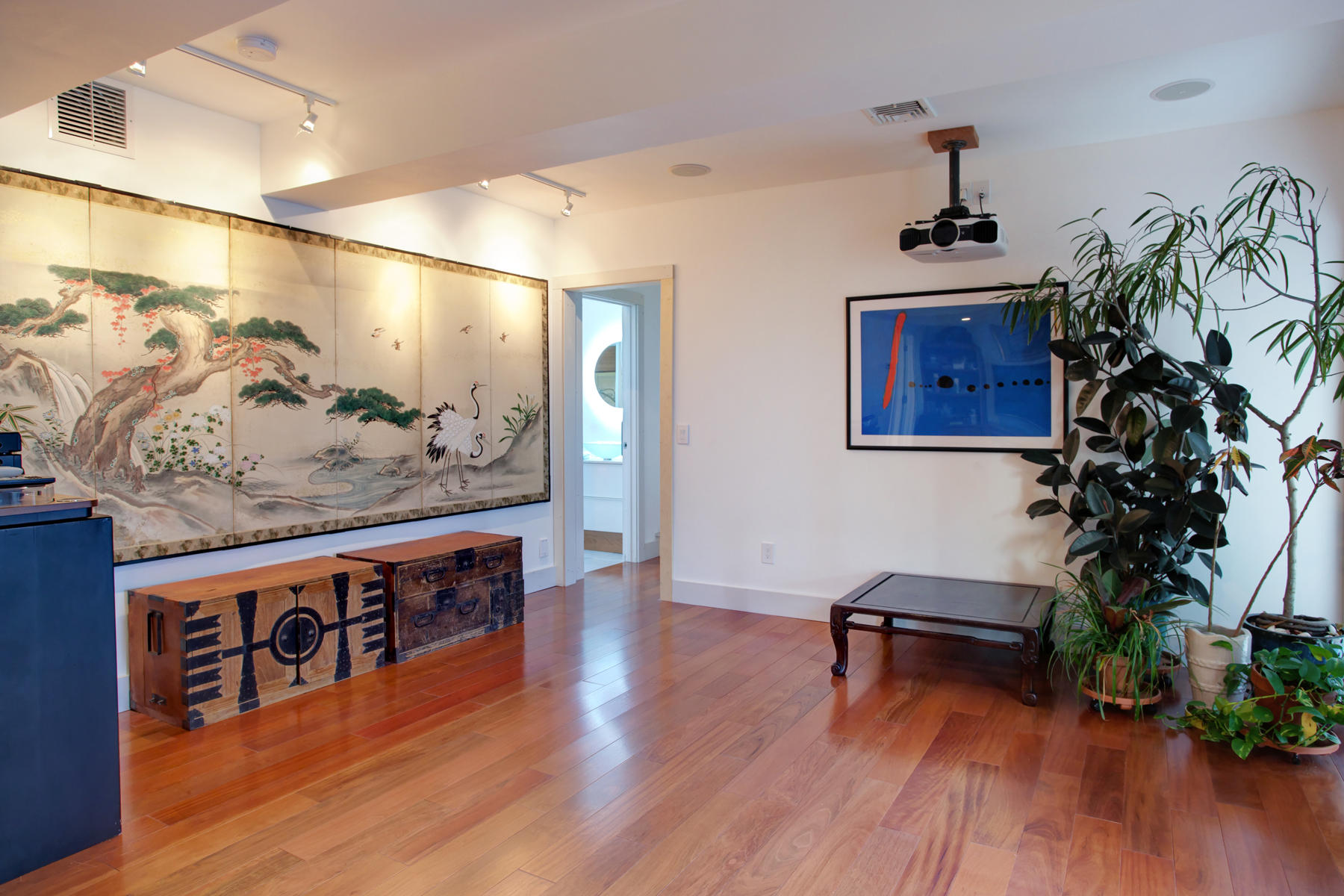 150 Holly Point Road Centerville, MA 02632 - Photo 20 of 28 a view of a hallway with wooden floor and potted plants