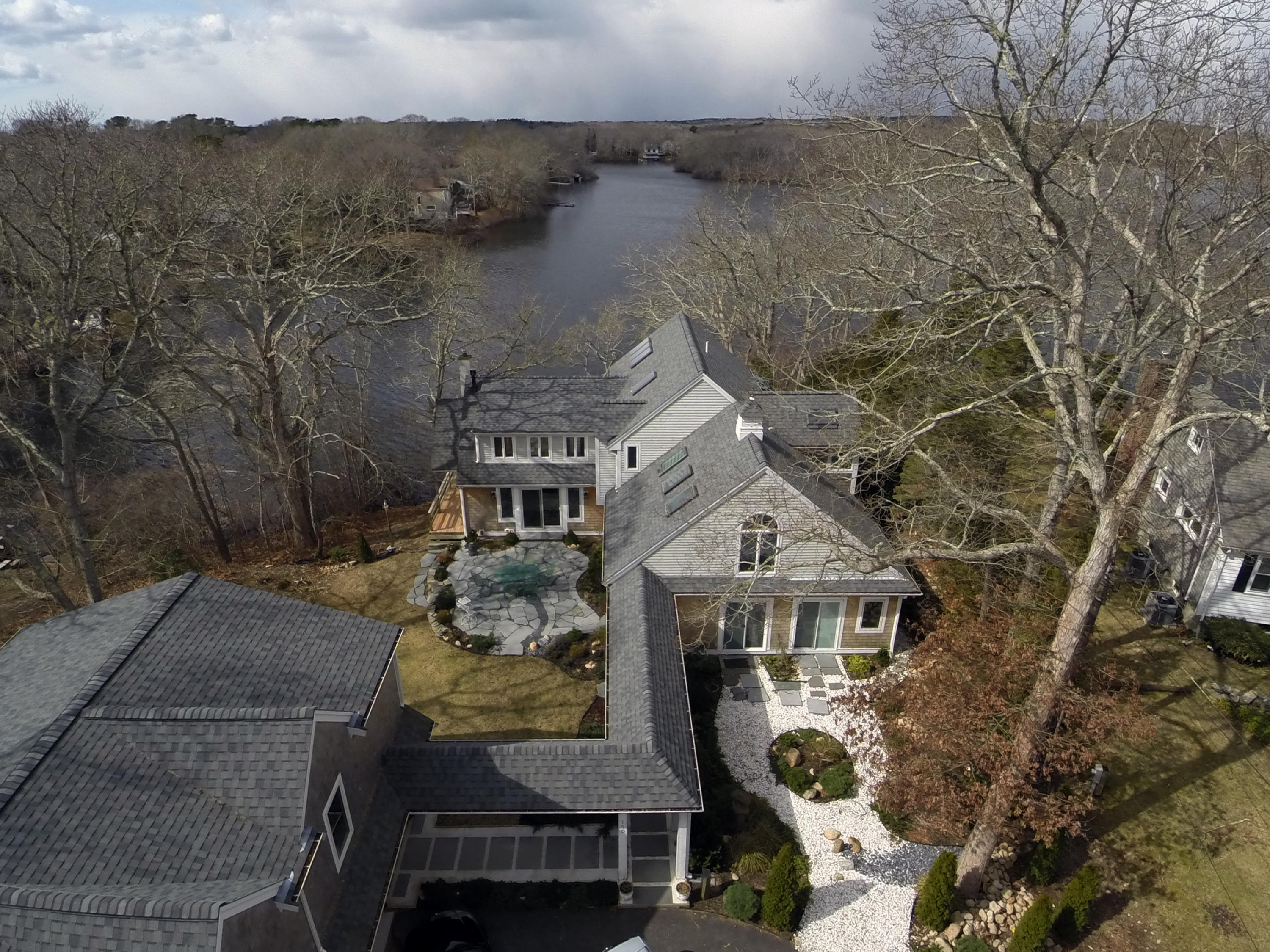 150 Holly Point Road Centerville, MA 02632 - Photo 2 of 28 an aerial view of a house with a yard