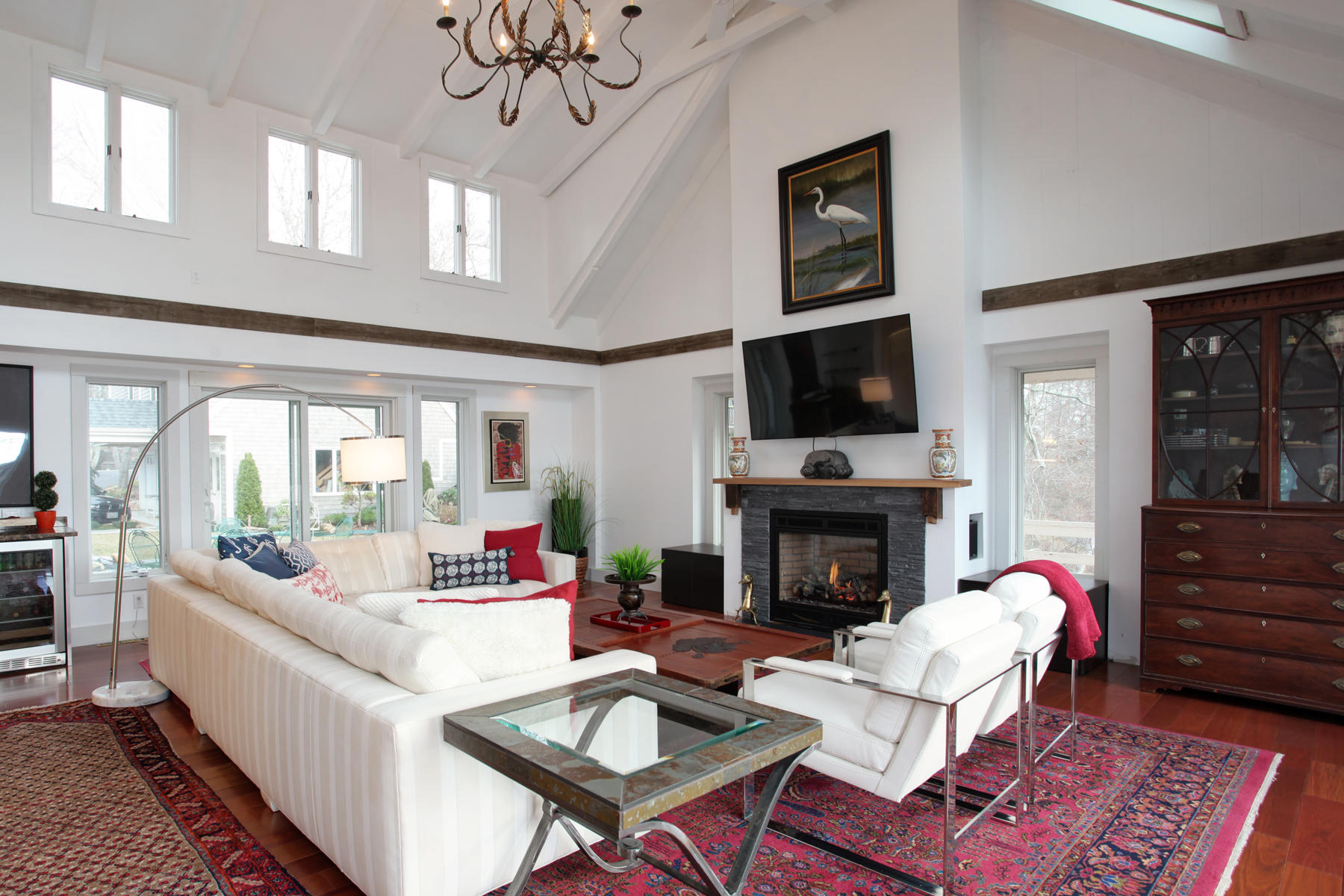 150 Holly Point Road Centerville, MA 02632 - Photo 6 of 28 a living room with furniture fireplace and a large window