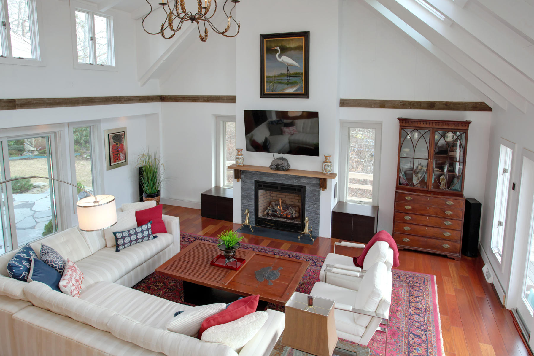 150 Holly Point Road Centerville, MA 02632 - Photo 7 of 28 a living room with furniture a flat screen tv and a fireplace