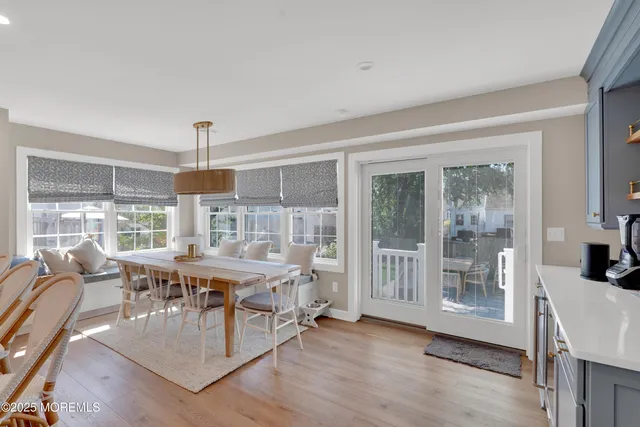 a very nice looking living room with a large window and wooden floor