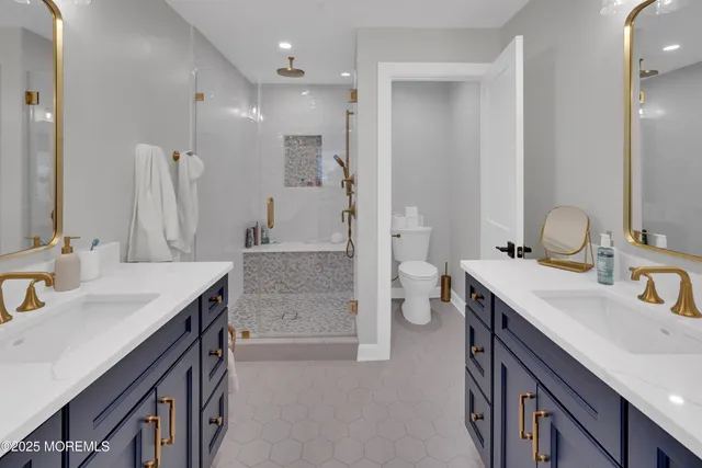 a spacious bathroom with a sink double vanity and a mirror