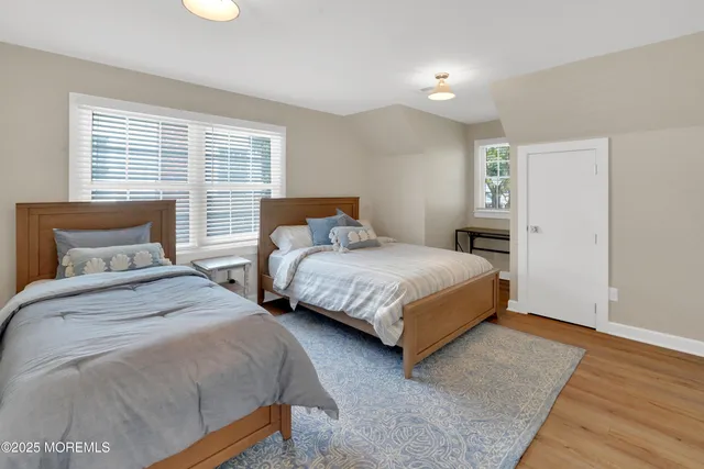 a bedroom with two beds and a window