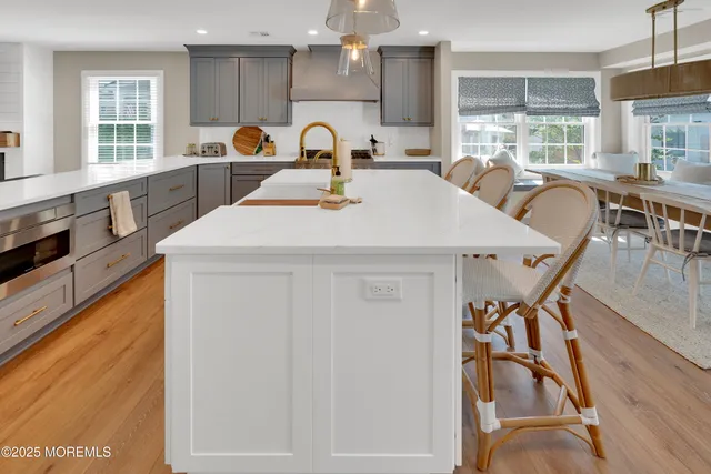 a kitchen with stainless steel appliances a table and chairs