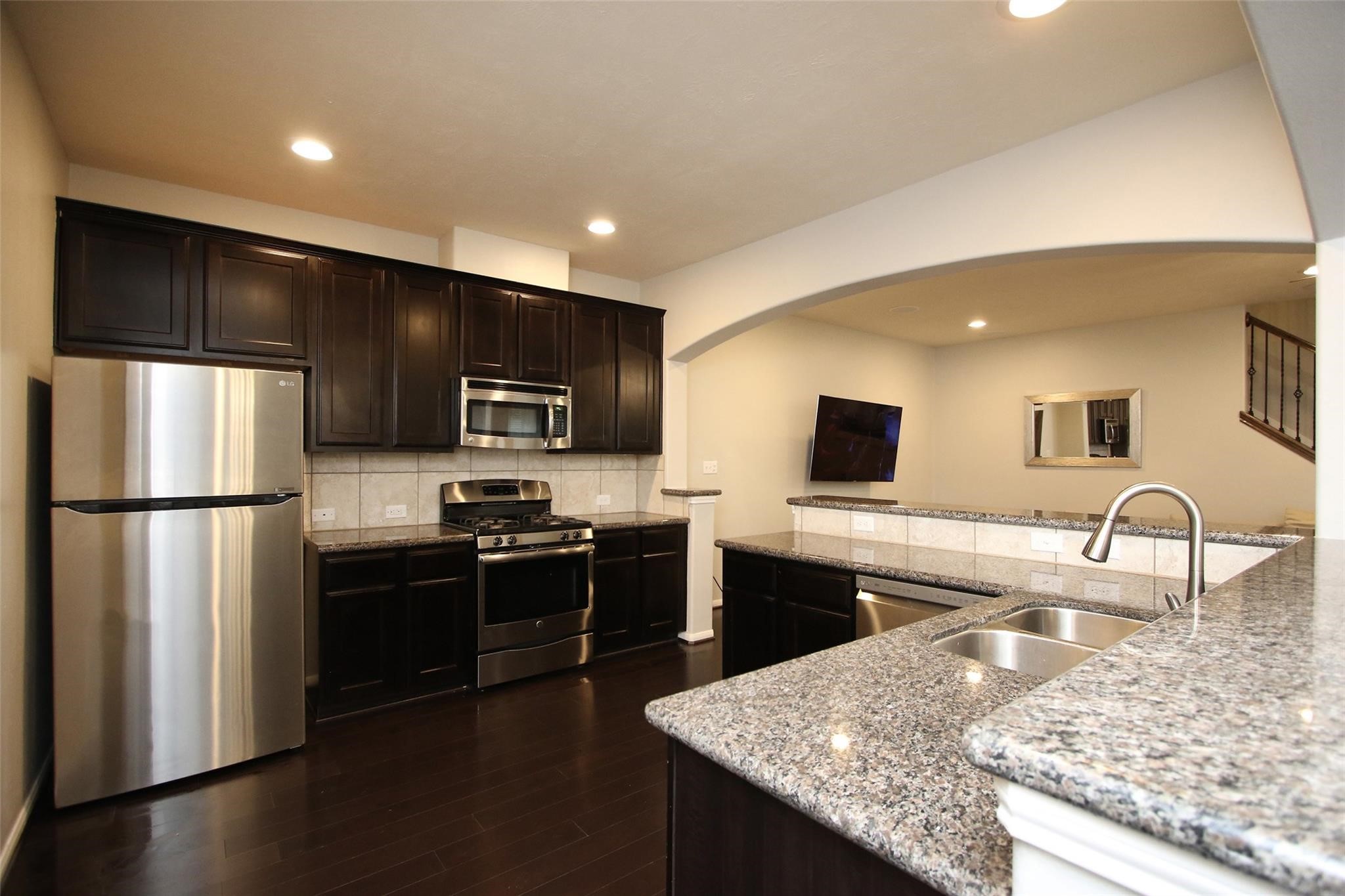 8517 Sunset Loch Drive Spring, TX 77379 - Photo 10 of 22 a kitchen with stainless steel appliances granite countertop a refrigerator stove microwave and sink
