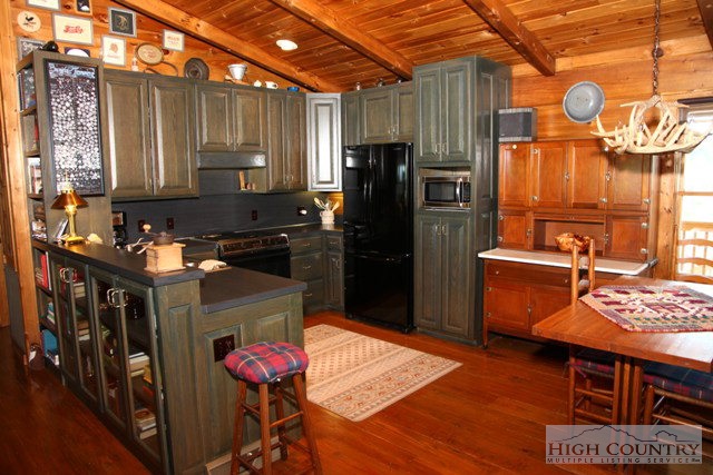 1242 Lazy Branch Road Ennice, NC 28623 - Photo 17 of 29 a kitchen with stainless steel appliances granite countertop a refrigerator and a stove