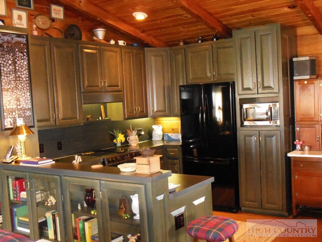 1242 Lazy Branch Road Ennice, NC 28623 - Photo 18 of 29 a kitchen with refrigerator and cabinets