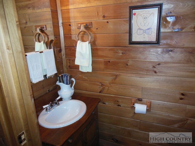 1242 Lazy Branch Road Ennice, NC 28623 - Photo 20 of 29 a bathroom with a sink and mirror