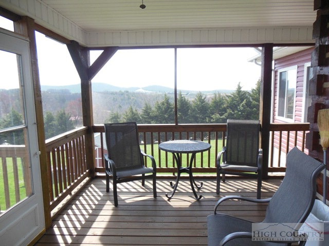 1242 Lazy Branch Road Ennice, NC 28623 - Photo 21 of 29 a view of a chairs and table on the deck