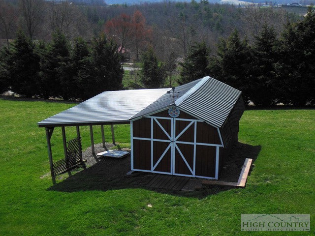 1242 Lazy Branch Road Ennice, NC 28623 - Photo 22 of 29 a front view of a house with garden